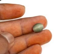 Quartz Cats Eye Lahsuniya 5.48 Carat in-hand view gray cabochon