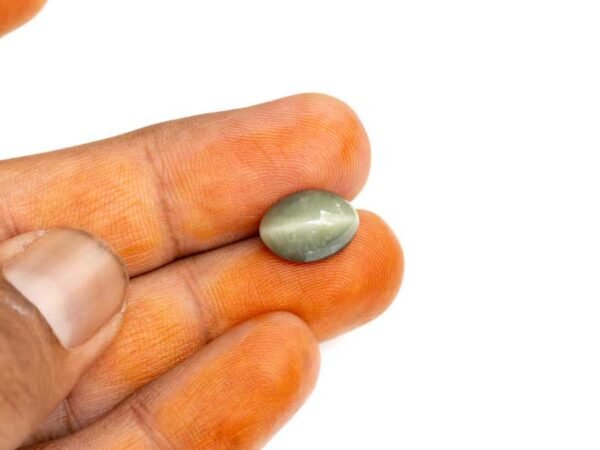 Quartz Cats Eye Lahsuniya 5.68 Carat in-hand view gray cabochon