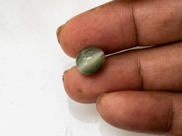 Quartz Cat's Eye Lahsuniya 6.79 carat in-hand actual size
