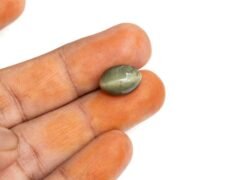 Quartz Cats Eye Lahsuniya 8.20 Carat in-hand view gray cabochon