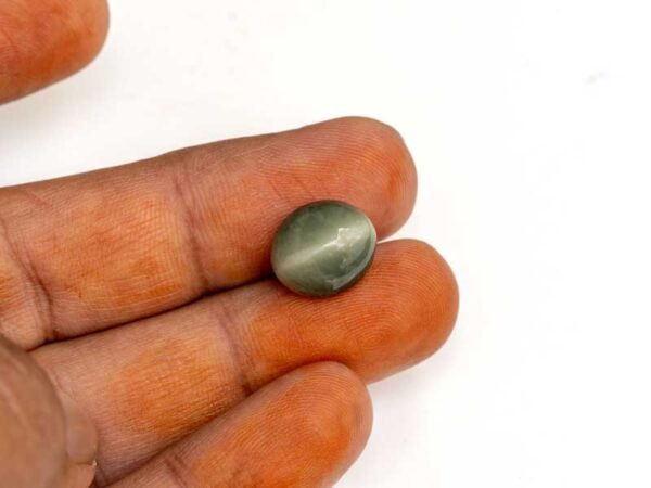 Quartz Cats Eye Lahsuniya 8.87 Carat in-hand view gray cabochon