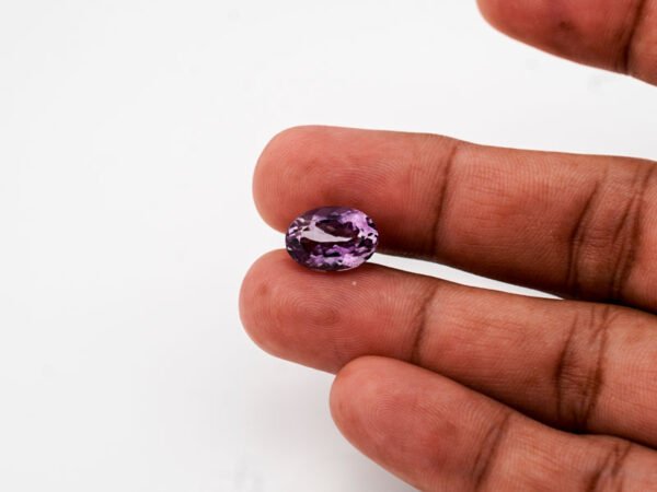 Natural Jamunia Stone Amethyst 6.34 carat in hand size reference