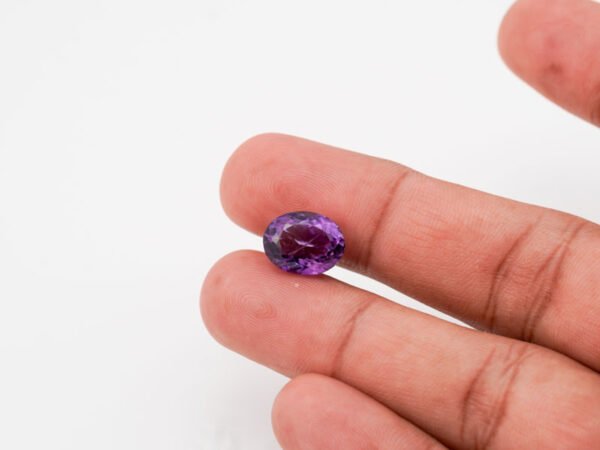 Natural Jamunia Stone Amethyst 6.77 carat in hand size reference