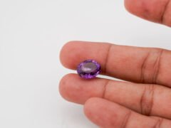 Natural Jamunia Stone Amethyst 7.43 carat in hand size reference