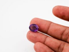 Natural Jamunia Stone Amethyst 7.77 carat in hand size reference