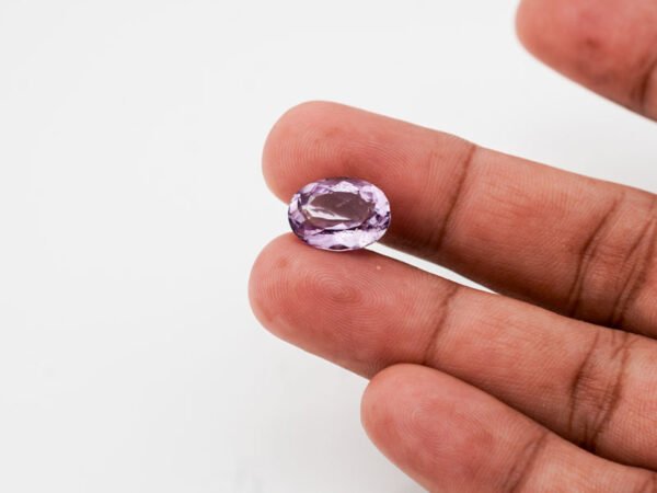 Natural Jamunia Stone Amethyst 7.92 carat in hand size reference