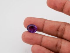 Natural Jamunia Stone Amethyst 8.28 carat in hand size reference