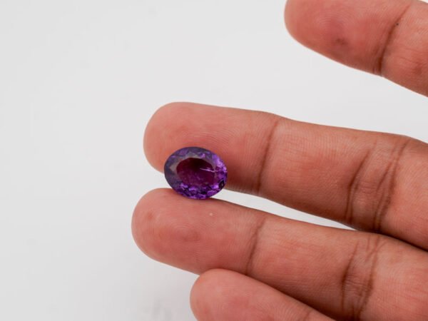 Natural Jamunia Stone Amethyst 8.28 carat in hand size reference