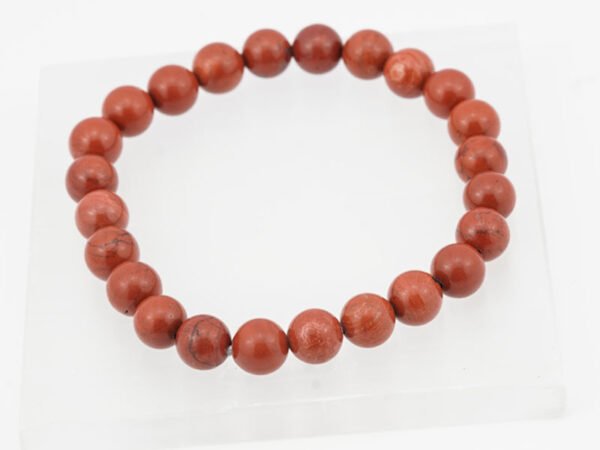 Original Red Jasper Bracelet 110 Carat placed on a white selenite plate